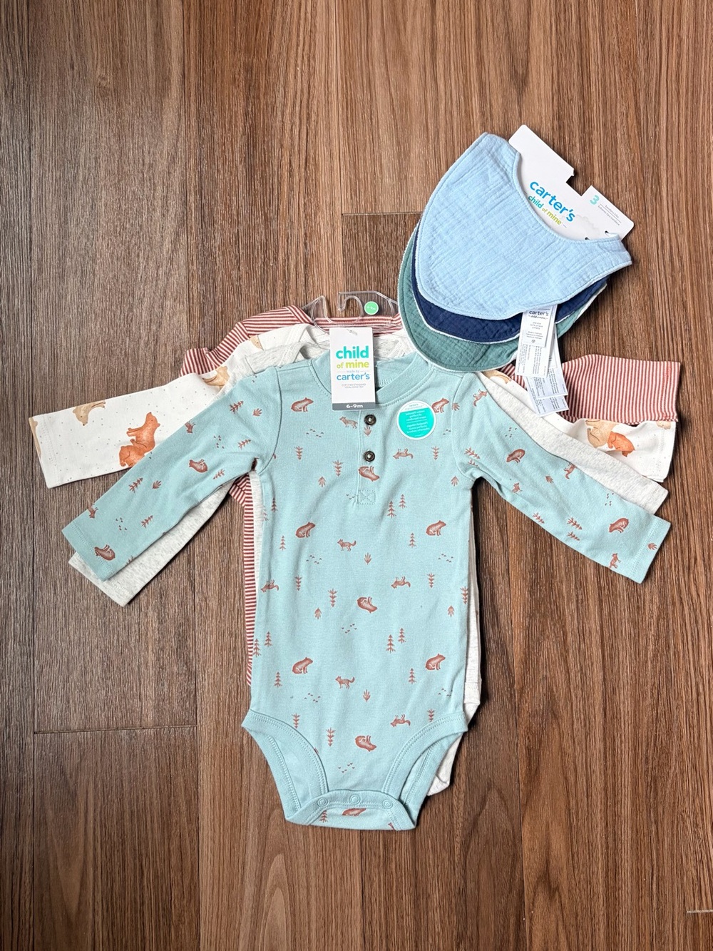 4 Pack 6-9 month onesies and 3 bibs